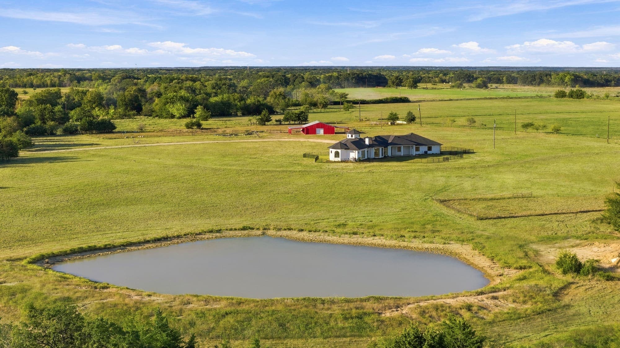 Aerial view of Freedom Estate showing the residence, barn, pond and private drive